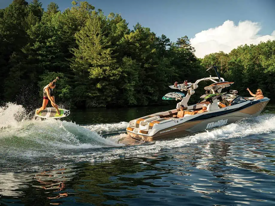 Tan Malibu Wakeboard Boat With Girl Wake Surfing